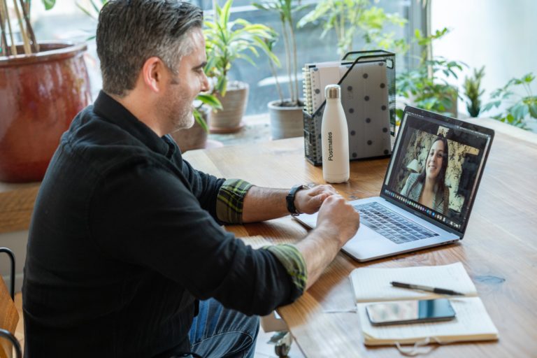 a man at a computer conference meeting